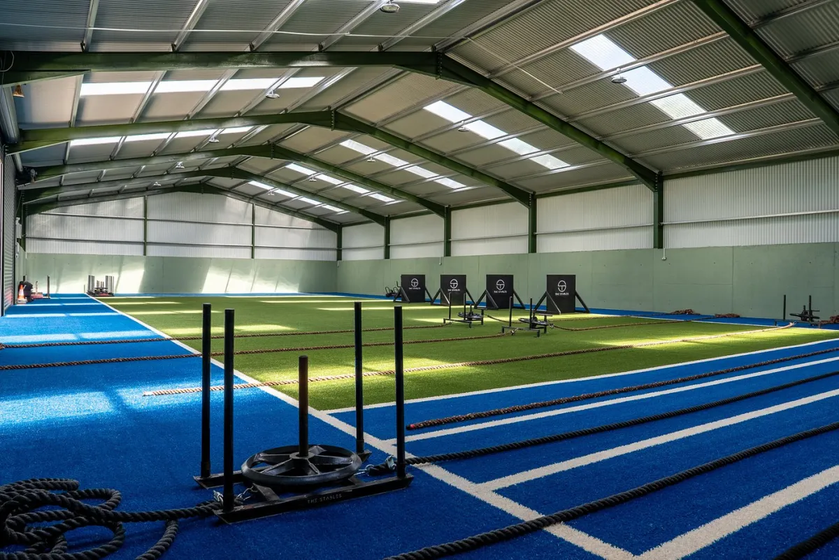 Indoor training facility with turf and sleds