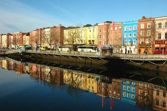 Colorful buildings reflected in a river.