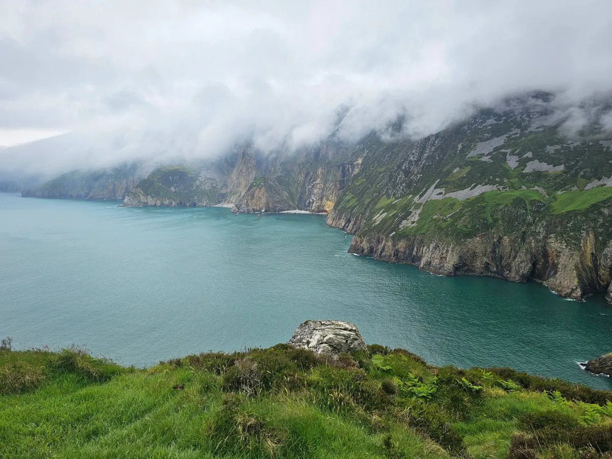 Cliffs and ocean with misty clouds