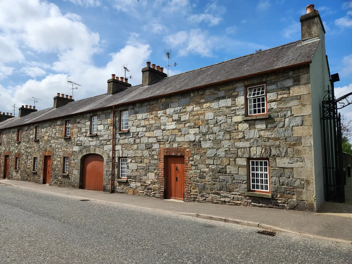 Stone building with red doors and windows
