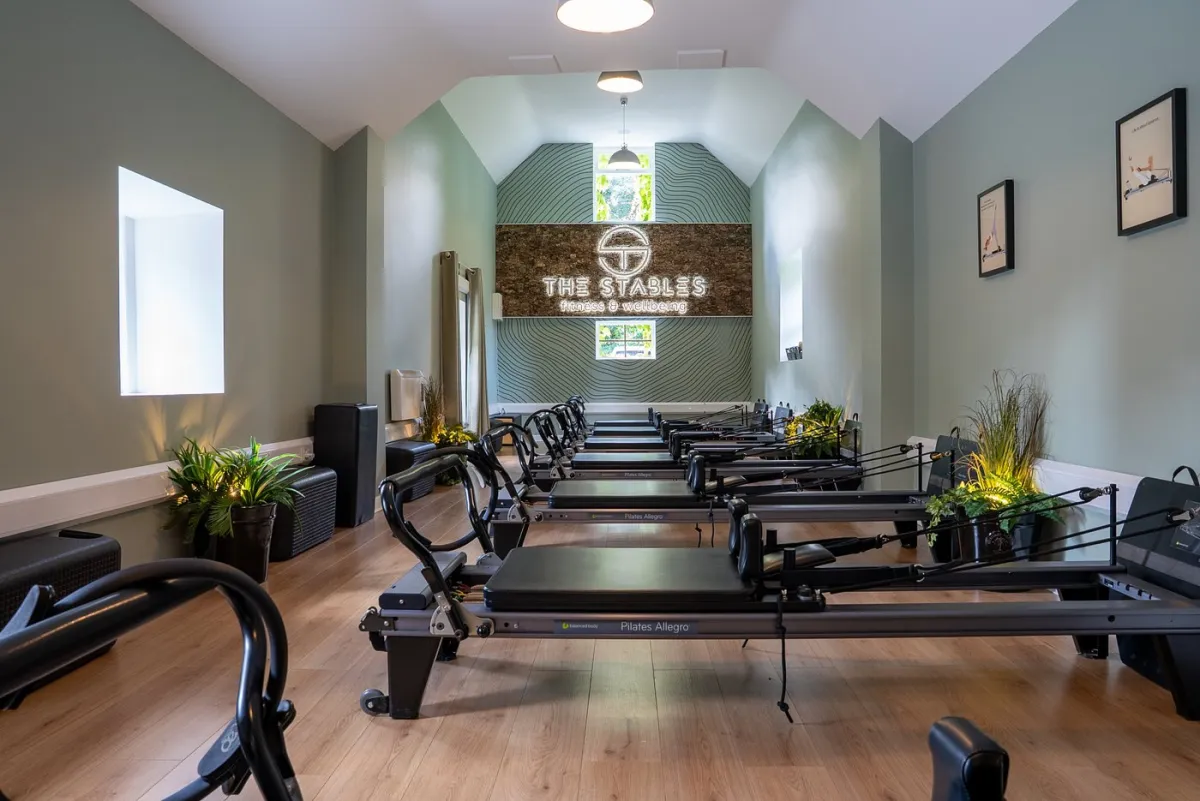 Pilates studio with reformer machines and plants