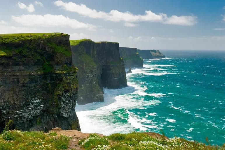 Cliffs overlooking the ocean with waves crashing below