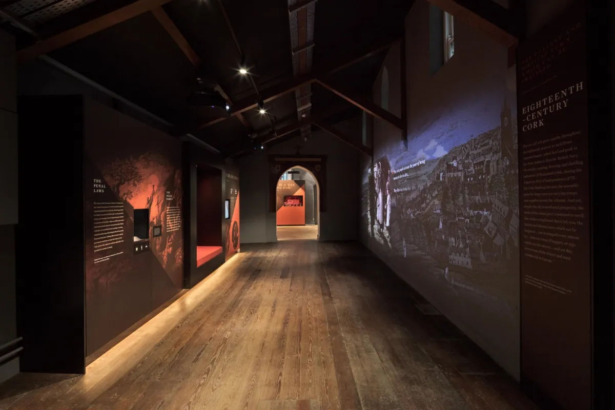 Dimly lit museum exhibit with historical displays.