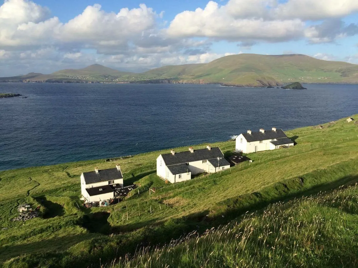 Coastal landscape with houses and green hills