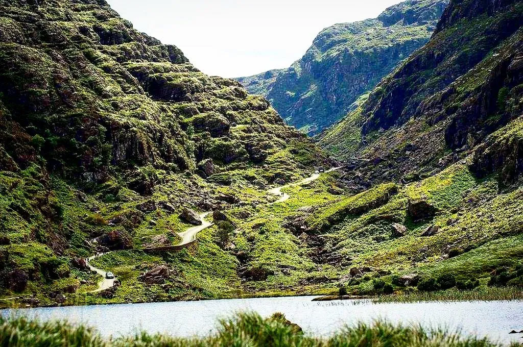 Scenic mountain valley with winding road and lake