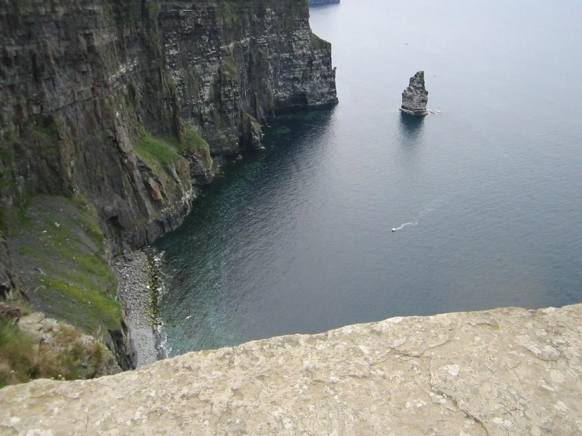 Cliffs and ocean with a rock formation.