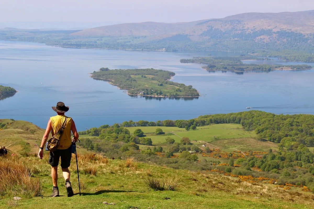 Hiker overlooking scenic lake and islands
