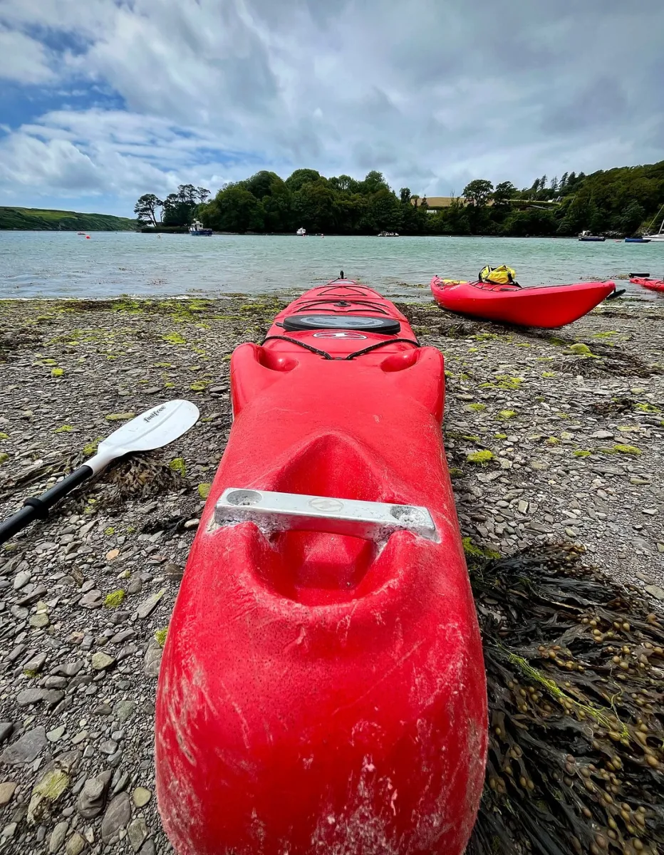 Atlantic Sea Kayaking recreation base Cork, red kayak on rocky shore