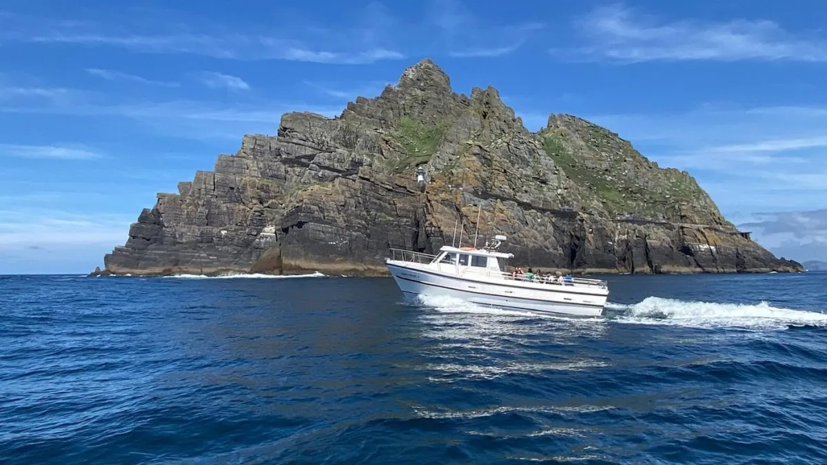 Boat sailing near a rocky island