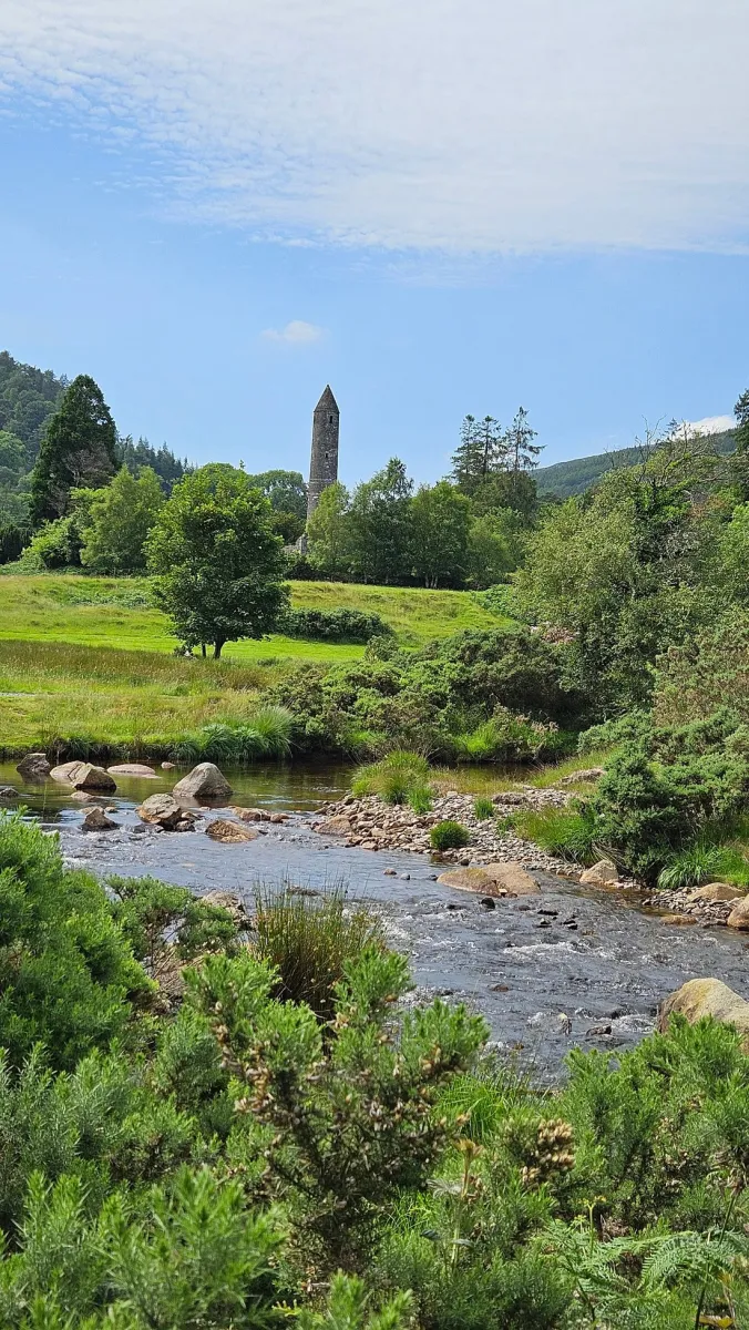 Scenic landscape with tower and stream.