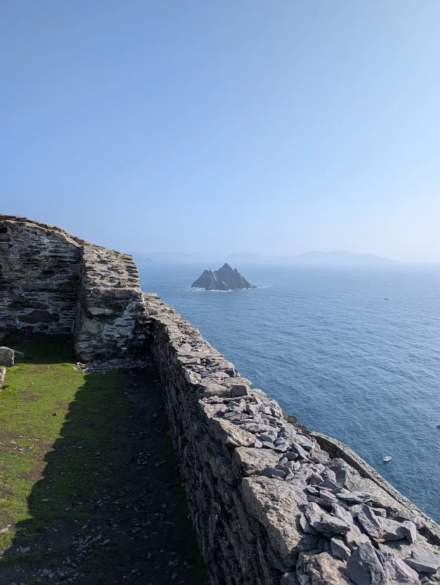 View of the Skellig Michael monastery ruins and surrounding rocky cliffs with the Atlantic Ocean