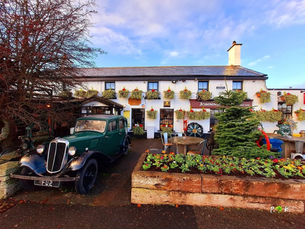 Vintage car parked in front of a decorated building.