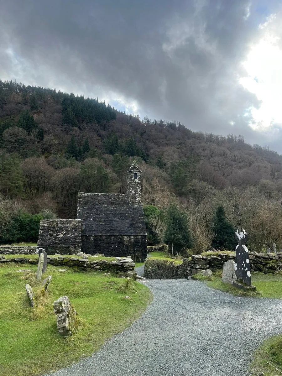 Stone church with graveyard in a hilly landscape