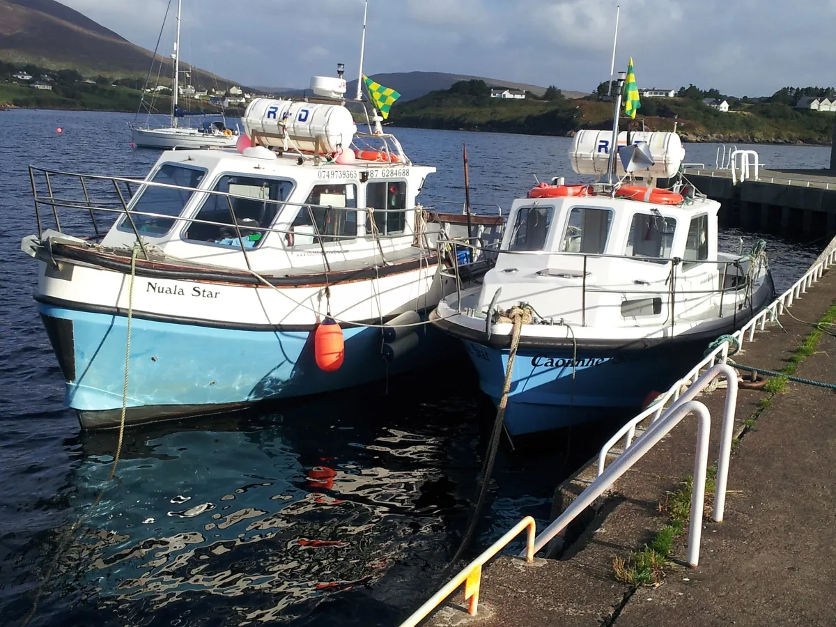 Two boats docked at a pier.