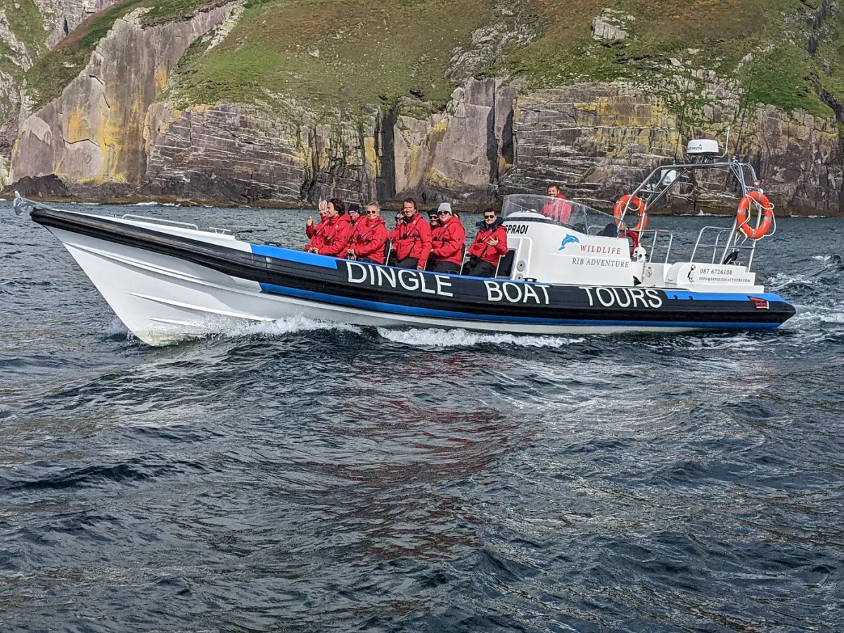 Tour boat with passengers in red jackets on the water