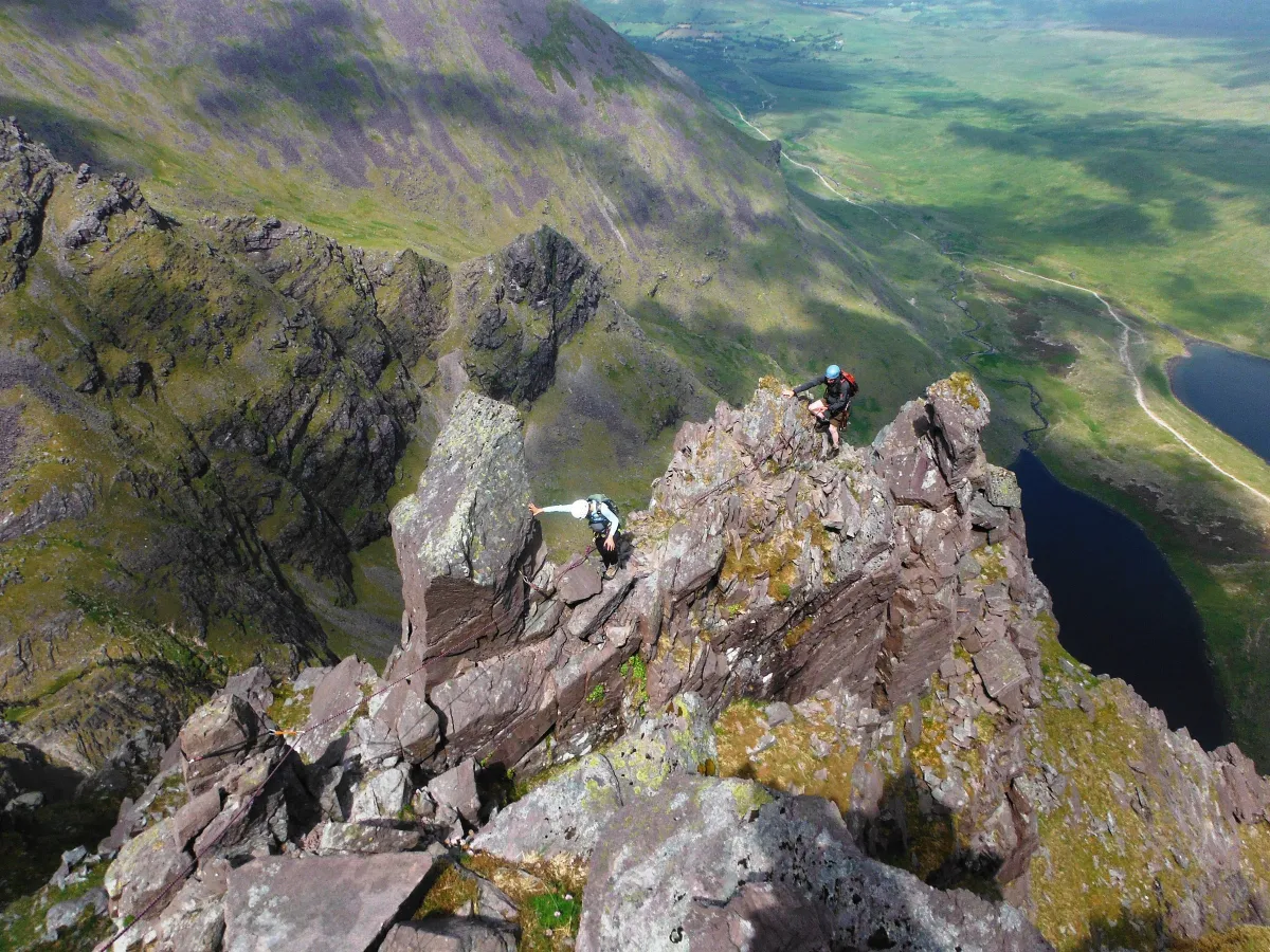 Two climbers on a rocky mountain ridge