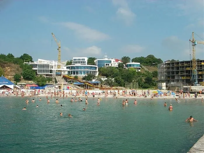 Пляж з людьми та будівництвом на задньому плані