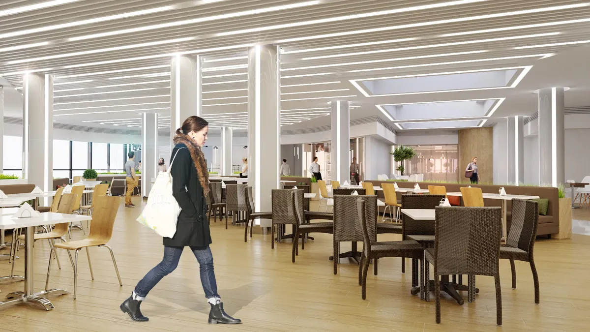 Жінка йде через сучасну їдальню.