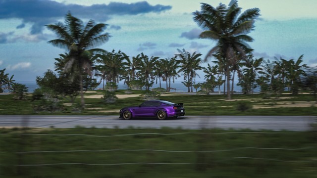 A side capture of a purple 2018 Ford Mustang RTR Spec 5 on a beachside road with cloudy skies, rows of palm trees, and the ocean in the distance. Brush and a barbed-wire fence blurs in the foreground due to the speed of the shot.