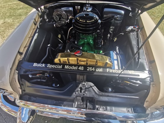 View of the engine bay of an American car. The engine is very clean and nicely detailed. On the front crossmember is a label which reads:
Buick Special Model 48 264 cui Fireball V8