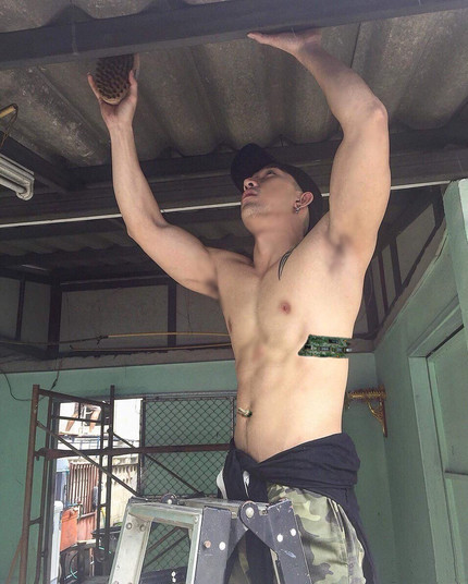 a shirtless muscular android wearing cargo pants stands on a ladder cleaning the overhead beams with his arms stretched over his head