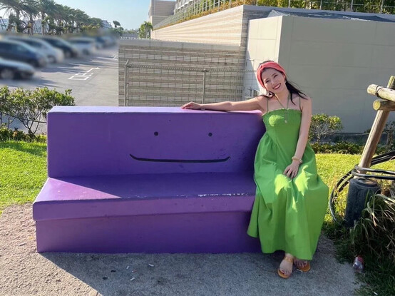 Chiemi sitting on a Ditto themed bench.