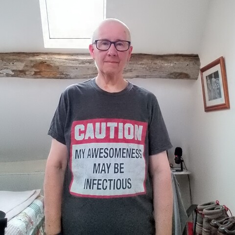 I'm in my home office which is also my bedroom, standing under a 17c beam and an attic window. I'm wearing a tee shirt that says, "Caution My awesomeness may be infectious" I found it in a thrift store. I guess the former owner was feeling less awesome when they gave it away.