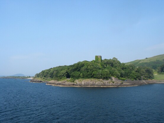Leaving Oban harbour on a great summer's day with a clear blue sky, while the ferry boat passes the lush green area of Dunollie Castle
