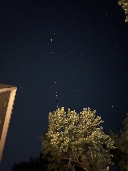 Photo of a satellite train flashing in a straight line across the Nebraska sky