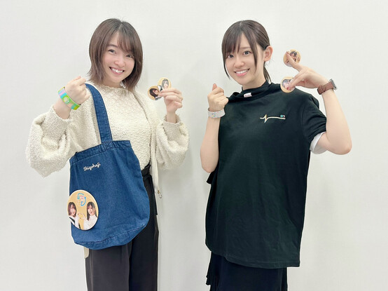 Reina and Rie showing off buttons with their faces from ShigoHaji..
