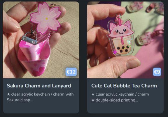 Screenshot of my Ko-Fi Shop, showing my Sakura Charm/Lanyard and my Cat Bubble Tea charm.