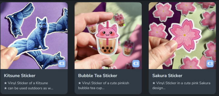 Screenshot of my Ko-Fi Shop, showing my Stickers of a Kitsune, Cat Bubble Tea and Sakura