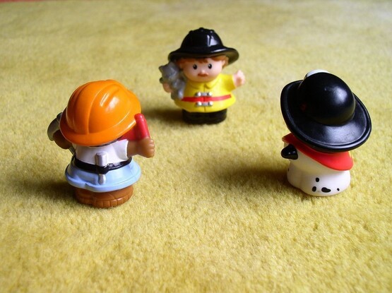 Group culture and event leadership: photograph of a group of three Playmobile model firefighters facing each other. Photo attribution: Flickr user bdld