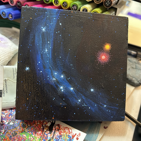 WIP square painting of black open space with blue dust veil sprinkled with white stars and a red+orange star binary
