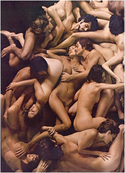 At least a dozen people writing together in a tasteful orgy photo for the Christmas 1972 issue of Playboy magazine