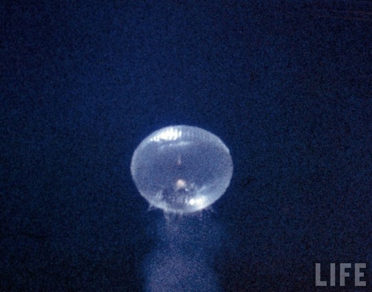 View of the launch of the Farside rocket from a stratospheric balloon at 100.000 ft. The rocket is ascending through the balloon which starts to burst. The test took place in October 1957, above Eniwetok Atoll in the Pacific Ocean.