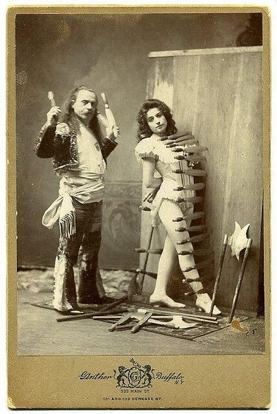 A cabinet card of a carnival knife thrower and his lovely assistant
