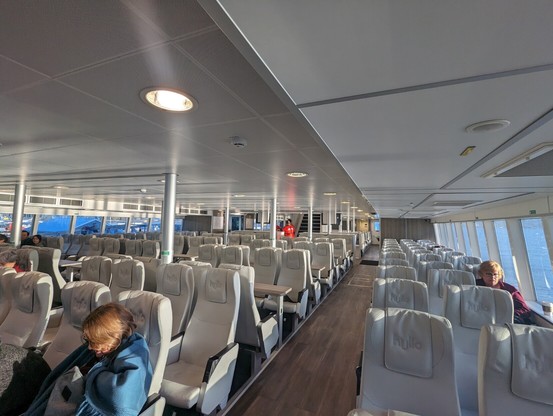 interior of a ferry with white skin seats
there are 4 sections of seats, side sections are 3 seats wide and, side sections are 4 seats wide