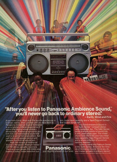 Earth, Wind and Fire stand around a Panasonic boombox with some type of fantastical light display