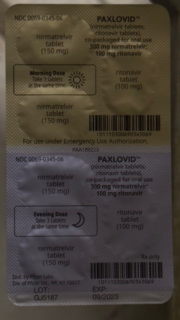 Back of Paxlovid dual dose foil pack in ambient light.  Hard to see difference in low illumination.