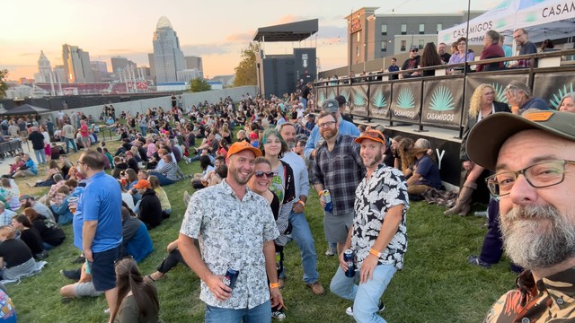 Folks pose for the camera outside a music venue in Northern Kentucky with the Cincinnati Skyline in the background