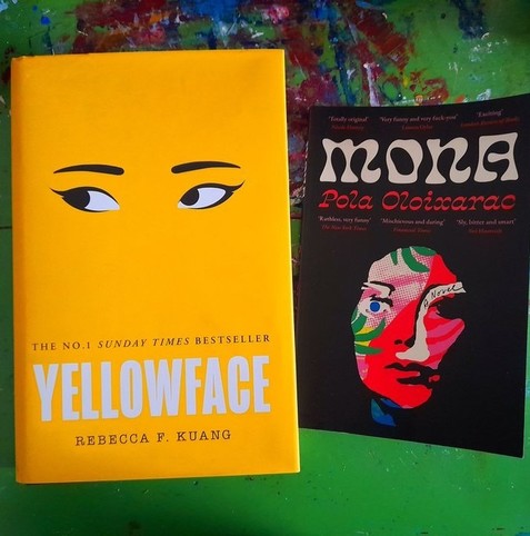 Two books, covers up: Yellowface by Rebecca F Kuang, and Mona by Pola Oloixarac. The former has a bright yellow cover with eyes and eyebrows, the latter a black cover with a collaged face.