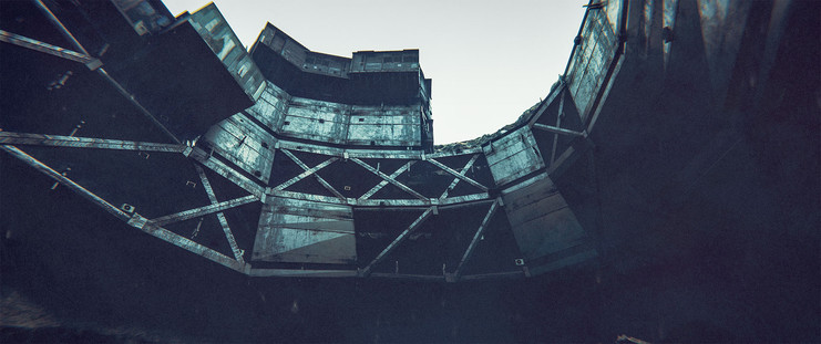 Wide shot, exterior, dusk - 

Looking across a crater that has been built up with various quick-and-dirty structures until the entire interior walls have been covered in a jumble of structures, girders and panels.