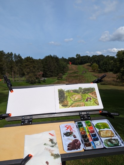 A photo of a watercolor painting on a sketch easel at storm king