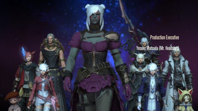 A screenshot from the end of the credits roll of Endwalker, for Final Fantasy XIV. Namhla Adaar is a max height female Roegadyn with dark grey skin and white hair, striding towards the camera with the rest of the Scions behind her.