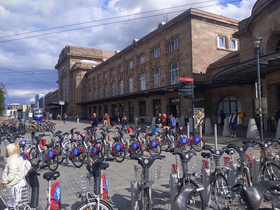 Many bicycles in front of Mulhouse-Ville railway station, right next to the tram-train stop.