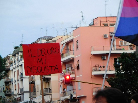red sin  at the same pride rally that reads :   " IL DECORO  MI  DISGUSTA "   ('decorum disgusts me'  in italian)