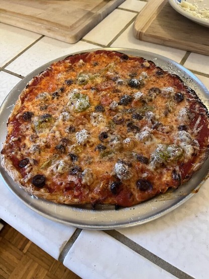 Last nightâ€™s pie - Chicago thin with sausage, olives and tomatoes
