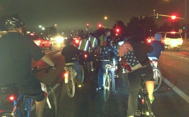 A group of night riders have stopped at a red light—awaiting their turn to proceed through an intersection—during a 2012 bike party in Salinas, California.