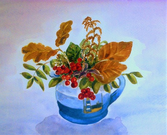 Autumn colored leaves and red berries in a blue painted jug